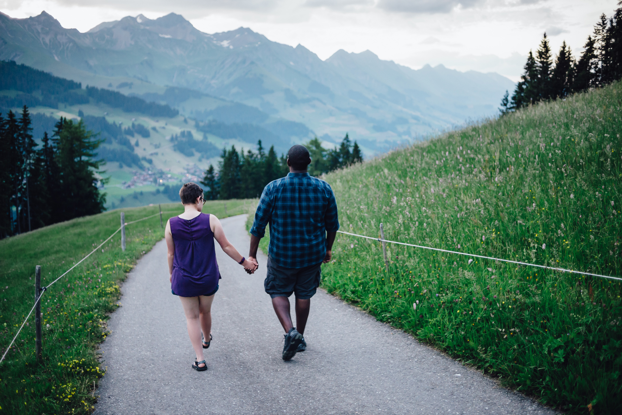 a couple walking away towards the mountains